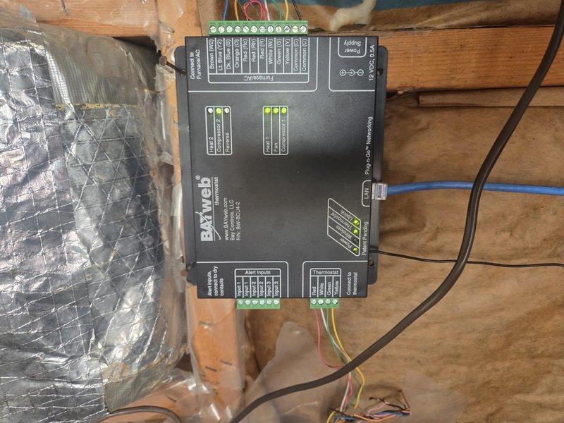 Responded to recurring compressor lockout issue on system less than 10 years old. Identified refrigerant leak at mechanical connection with visible oil residue. Verified BMWeb controller was operational with proper signal indicators illuminated, suggesting control system functioning correctly. Serviced system to restore heat functionality.