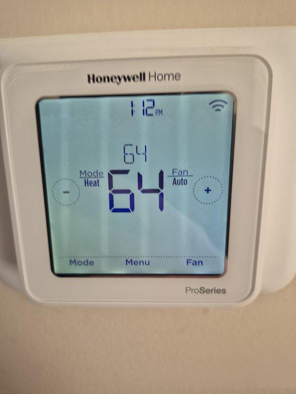 Conducted routine maintenance check on two heating systems. Inspected Honeywell Home ProSeries thermostats on both systems, confirming proper operation with appropriate temperature settings (64°F and 68°F) and verified WiFi connectivity on both units.
