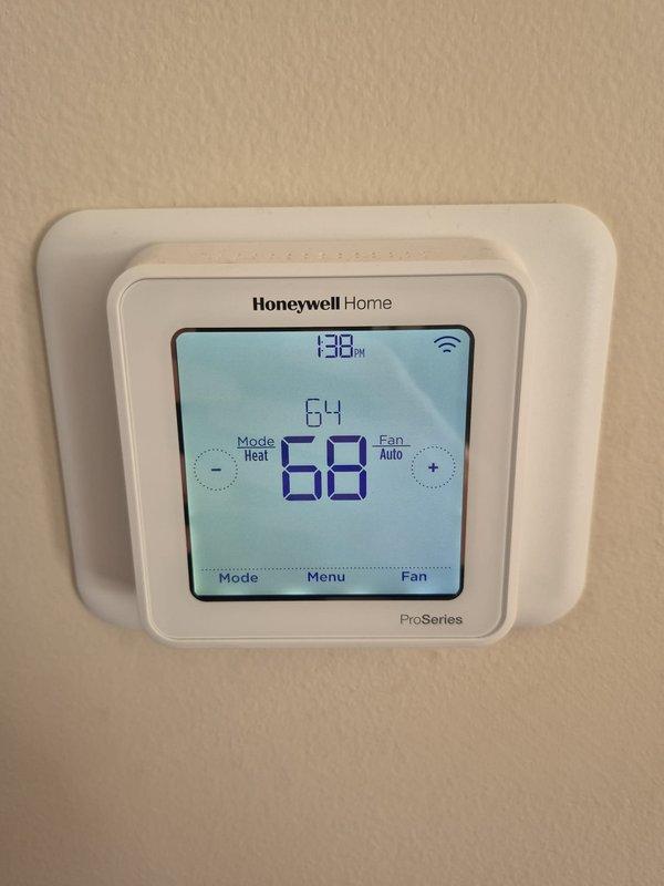 Conducted routine maintenance check on two heating systems. Inspected Honeywell Home ProSeries thermostats on both systems, confirming proper operation with appropriate temperature settings (64°F and 68°F) and verified WiFi connectivity on both units.