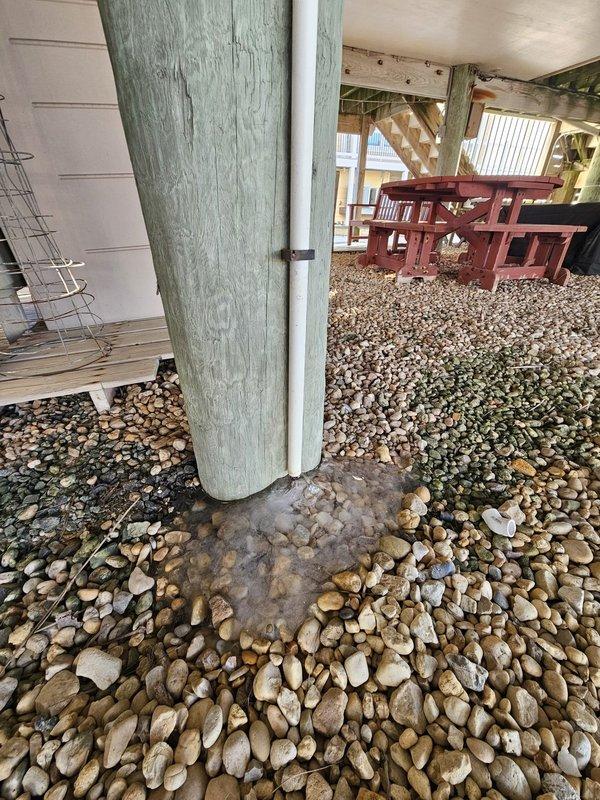 Responded to customer call regarding system malfunction following recent power outage. Inspected Carrier unit installed in elevated wooden enclosure with proper yellow gas line connections. System was successfully restored to normal operation after power cycle and control verification. Customer's credit card on file was billed for standard tune-up service.