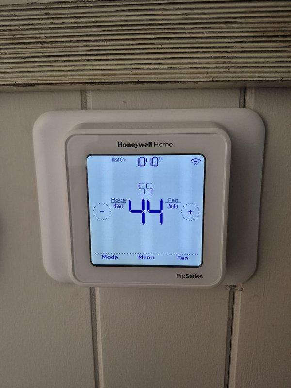 Responded to no heat complaint with downstairs unit non-operational and thermostat blank. Discovered power issue to thermostat, restored power and verified proper operation. System now functioning with heat output confirmed at 44°F with setpoint of 55°F. All components operating within normal parameters.