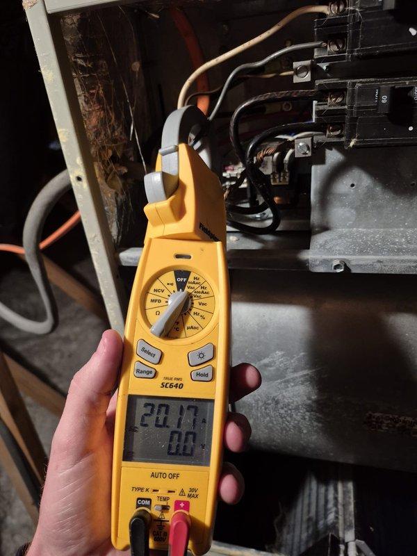Performed scheduled tune-up service on HVAC system. Conducted electrical diagnostics using clamp meter on circuit panel, verifying proper voltage readings and connections. Inspected ecobee smart thermostat functioning at 70°F with 29% battery remaining, confirming proper operation and temperature settings.