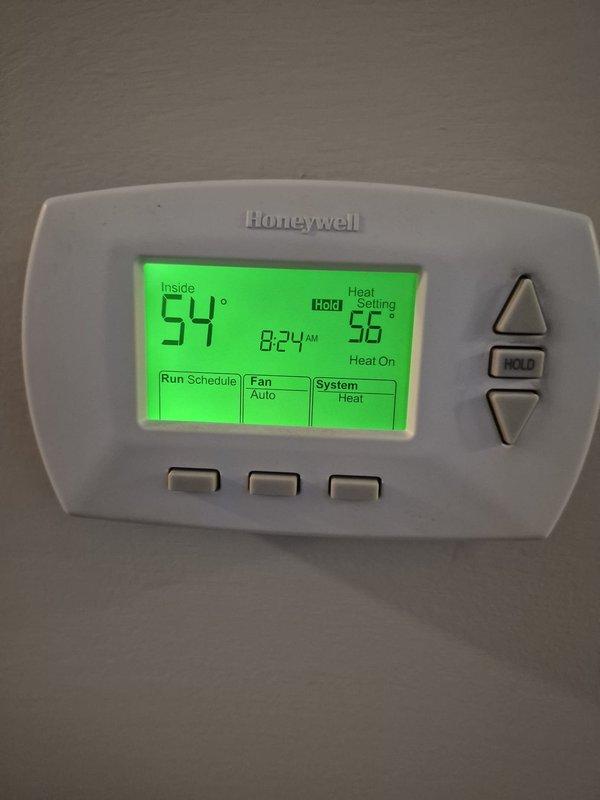 Responded to no-heat emergency call. Diagnosed complete freezing of condensate line from exterior to furnace trap. Existing heat tape was non-functional. Installed approximately 15 feet of new heat tape with plug and three 1-1/8" aramaflex insulation pieces to prevent future freezing. System restored to proper operation as confirmed by thermostat function.