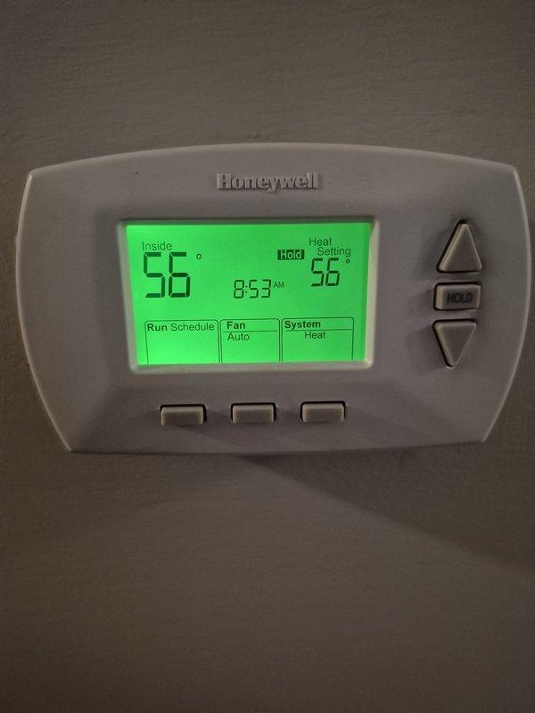 Responded to no-heat emergency call. Diagnosed complete freezing of condensate line from exterior to furnace trap. Existing heat tape was non-functional. Installed approximately 15 feet of new heat tape with plug and three 1-1/8" aramaflex insulation pieces to prevent future freezing. System restored to proper operation as confirmed by thermostat function.