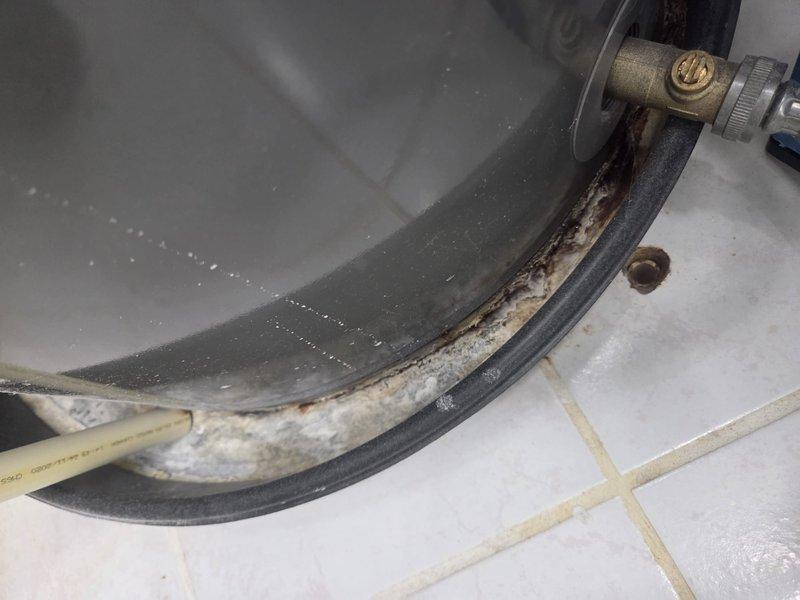 Performed scheduled heating maintenance service on dual-system setup. Inspected water heater showing significant corrosion and mineral buildup along the gasket seam. Examined mechanical room equipment including water treatment system with connected PVC piping, pump controller, and return air filtration. Customer's maintenance agreement requires renewal.