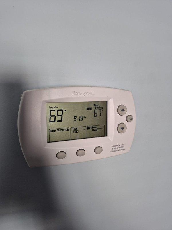 Responded to service call for Heil heat pump (model NXH536GKA100, serial E134107802) that was constantly running without shutting off. Diagnosed faulty outdoor unit fan motor and defective 50/5 UF capacitor. Replaced both components, which restored proper system cycling and operation. Upon completion, verified thermostat was properly controlling system with heat setting at 66°F and confirmed normal operation.