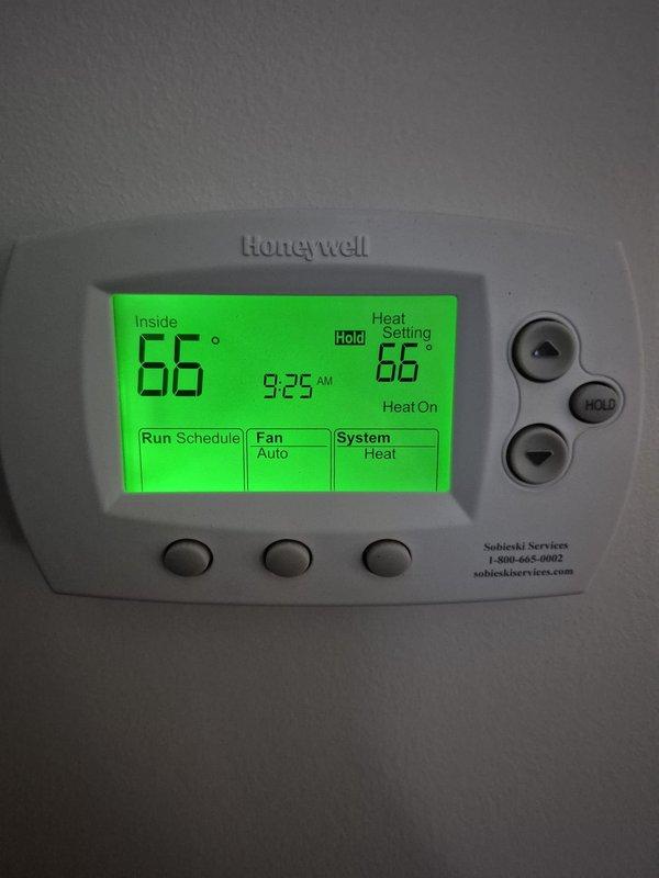 Responded to service call for Heil heat pump (model NXH536GKA100, serial E134107802) that was constantly running without shutting off. Diagnosed faulty outdoor unit fan motor and defective 50/5 UF capacitor. Replaced both components, which restored proper system cycling and operation. Upon completion, verified thermostat was properly controlling system with heat setting at 66°F and confirmed normal operation.