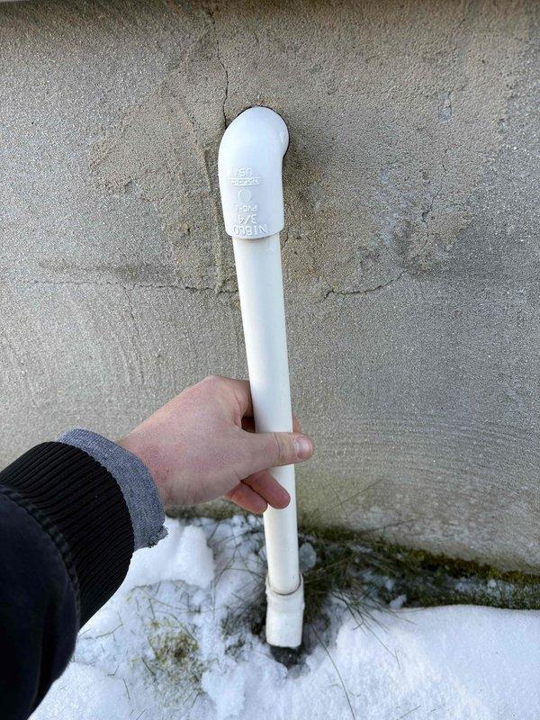 Responded to no heat call. Discovered blocked exhaust pipe on exterior wall; removed snow accumulation and replaced damaged PVC elbow fitting that was restricting proper ventilation. System restored to normal operation after clearing obstruction.