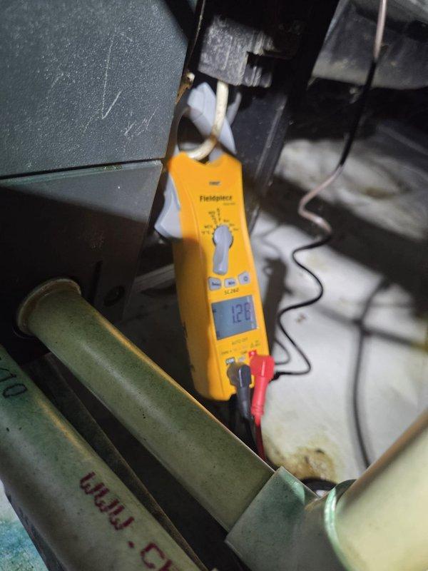 Conducted routine heating system maintenance. Performed electrical diagnostics with amp readings of 128 on system components and verified thermostat functionality. System was operating normally in heating mode with temperature set to 65°F.