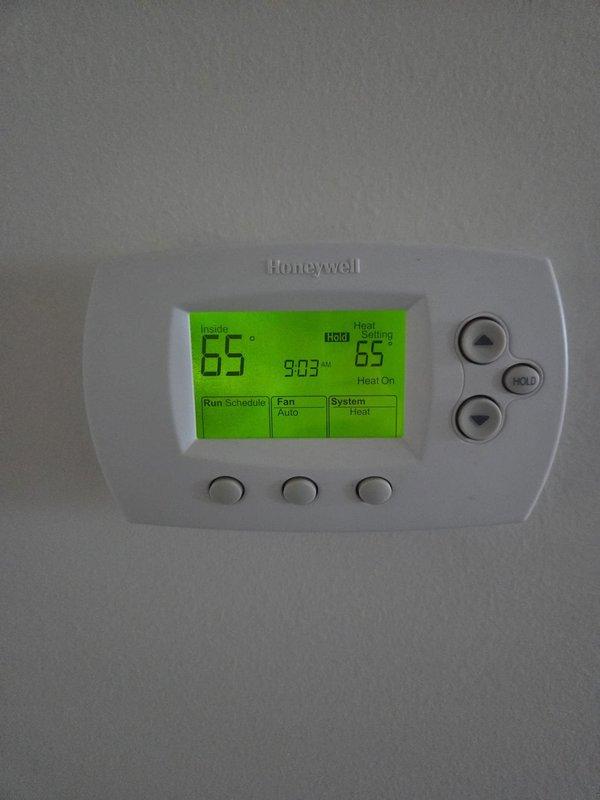 Conducted routine heating system maintenance. Performed electrical diagnostics with amp readings of 128 on system components and verified thermostat functionality. System was operating normally in heating mode with temperature set to 65°F.