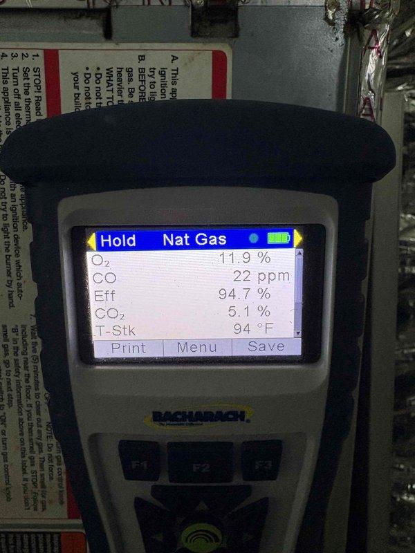 Responded to no heat complaint in downstairs zone. Conducted combustion analysis using Bacharach analyzer which showed system operating at 94.7% efficiency with safe CO levels (22ppm) and normal stack temperature (94°F). Identified condensate drainage issue with improper installation of condensate line and filter. Corrected plumbing configuration and secured connections properly to ensure proper condensate removal, restoring normal heating operation.