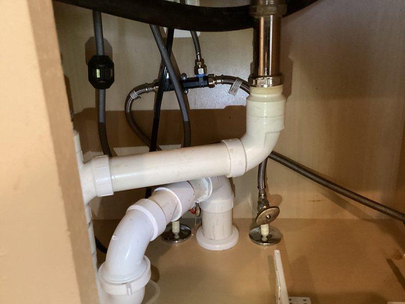 Successfully installed a Grundfos UP15-10SU7P hot water circulating pump on top of the customer's electric water heater in the garage. The installation included connecting the TLC recirculation pump with stainless steel lavatory supply lines and a plastic recirculation tee connector, along with necessary brass fittings to ensure proper functionality of the hot water circulation system.