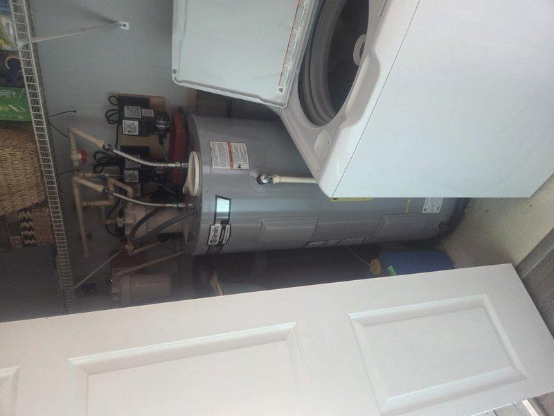 Performed routine heating maintenance service on residential HVAC system. Inspected outdoor condenser unit and verified proper operation. Examined water heater system and associated plumbing connections in utility area to ensure all components functioning correctly.