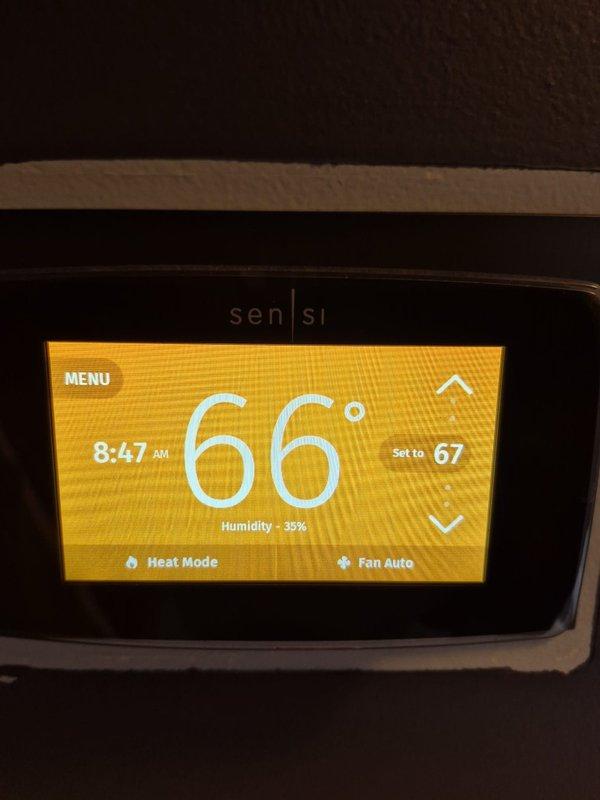 Performed scheduled heating maintenance service including electrical system diagnostics with Fieldpiece SC440 multimeter at exterior junction box. Inspected and verified proper electrical connections to heating system. Confirmed thermostat functionality with Sensi smart thermostat operating correctly in heat mode (66°F current/67°F set point) with 35% humidity reading.