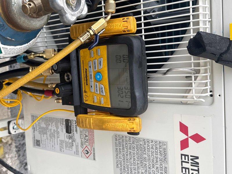 Successfully completed installation of a Mitsubishi Electric mini-split system with PUZ-AK12NL heat pump and PKA-AL12NL fan coil unit. Mounted outdoor unit on wall bracket on elevator shaft roof and installed indoor fan coil above machine room door, with refrigerant lines concealed in metal top hat and properly fire caulked. System includes PAR-FL32MA wireless remote control, Gobi II condensation pump, and surge disconnect, with all connections tested and verified operational.
