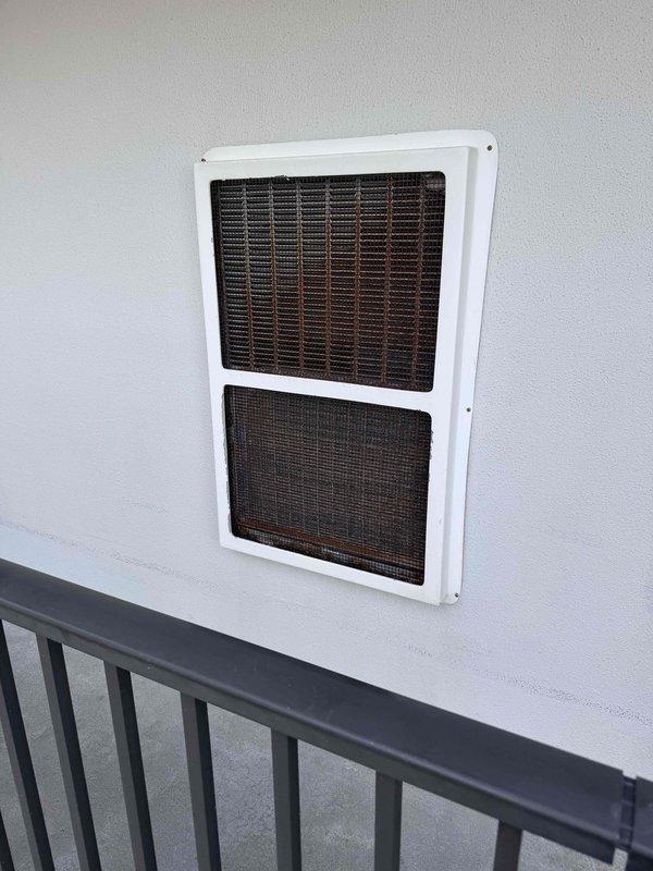 Conducted assessment of packaged HVAC unit in condo unit 2010 showing significant dust accumulation and discoloration. Inspection revealed deteriorated ventilation components including return air vent with clogged filter material. Recommended complete system replacement due to age-related wear and compromised efficiency.