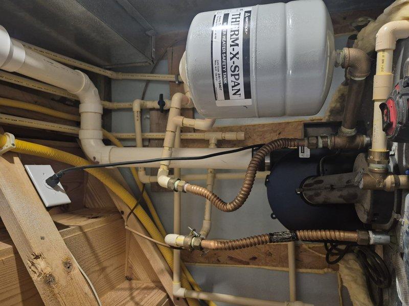 Performed inspection of existing water heater system with insulated tank and associated plumbing components. Assessed current installation which includes expansion tank, PVC and copper piping, shutoff valves, and circulation pump. Provided customer with replacement options for standard tank water heater as well as tankless alternatives per their request.
