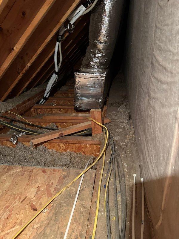 Removed old geothermal split system from bonus room kneewall location and installed new Mitsubishi ductless system consisting of MUZ-GX12NL 12,000 BTU 25 SEER outdoor heat pump unit and MSZ-GX12NL wall-mounted indoor air handler with remote thermostat. Positioned outdoor unit on custom wooden stand near crawlspace entrance, reused and extended existing disconnect, and ran new lineset following previous geothermal split system pathway.