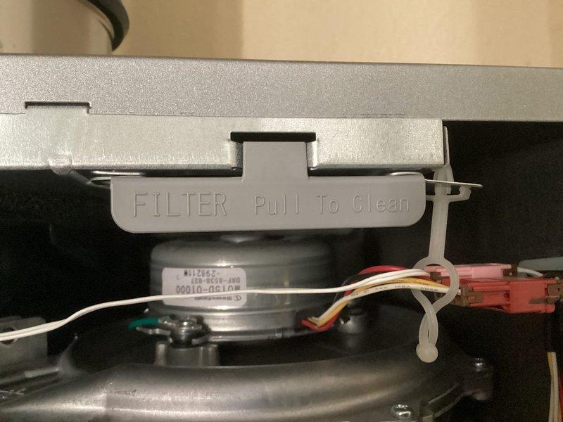 Performed scheduled maintenance on tankless water heater system. Inspected brass valves, fittings, and PVC drainage components, confirming all were in proper working condition. Removed and cleaned filter as indicated by "Pull To Clean" access tab, and checked motor connections to ensure proper electrical functionality.