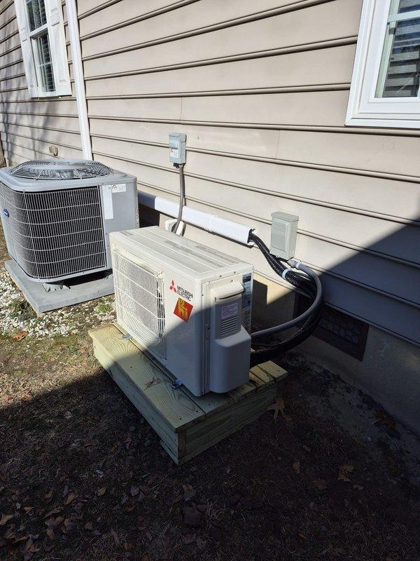 Successfully installed a Mitsubishi mini-split system with outdoor condenser unit mounted on a wooden platform. Completed all necessary electrical connections through junction box and ran refrigerant lines to the interior. System was properly staged prior to installation and thoroughly tested for optimal performance.
