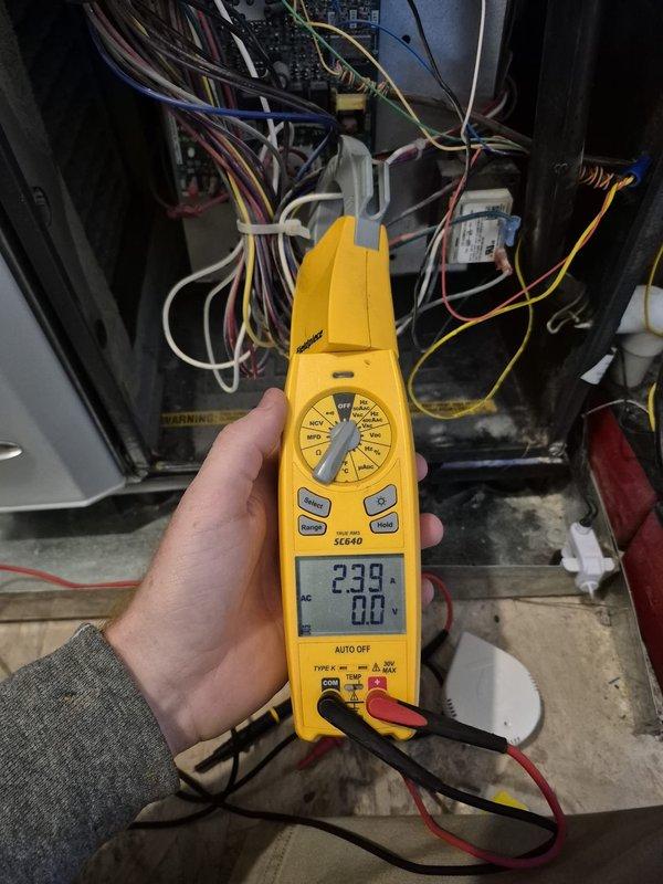Performed routine heating system maintenance and inspection. Conducted electrical testing of HVAC components using Fieldpiece SC440 meter, confirming proper voltage readings. Verified thermostat operation with system maintaining 68° indoor temperature at 27% humidity while outdoor conditions were 36°/91%.