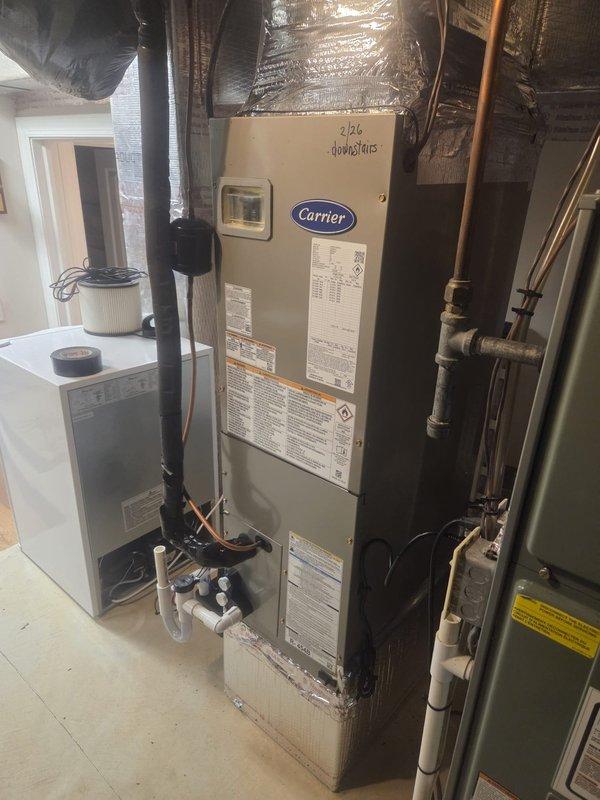 Performed pump down of refrigerant charge and shortened lineset at the run out before the bend up on Carrier HVAC system. Equipment includes furnace unit with connected ductwork, properly insulated with reflective material, and PVC drain lines installed according to manufacturer specifications.