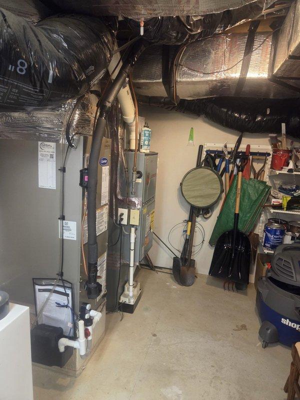 Performed pump down of refrigerant charge and shortened lineset at the run out before the bend up on Carrier HVAC system. Equipment includes furnace unit with connected ductwork, properly insulated with reflective material, and PVC drain lines installed according to manufacturer specifications.