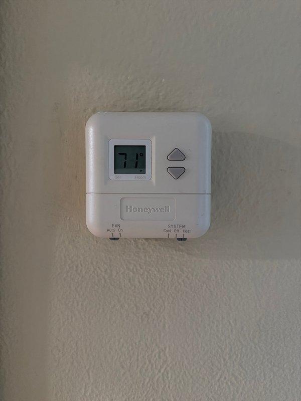 Performed assessment for potential system replacement of aging natural gas HVAC unit located in first floor storage closet. Unit is currently operational but at end of expected service life (original installation circa 2002). Documented existing Honeywell thermostat configuration and current wiring connections for replacement planning.