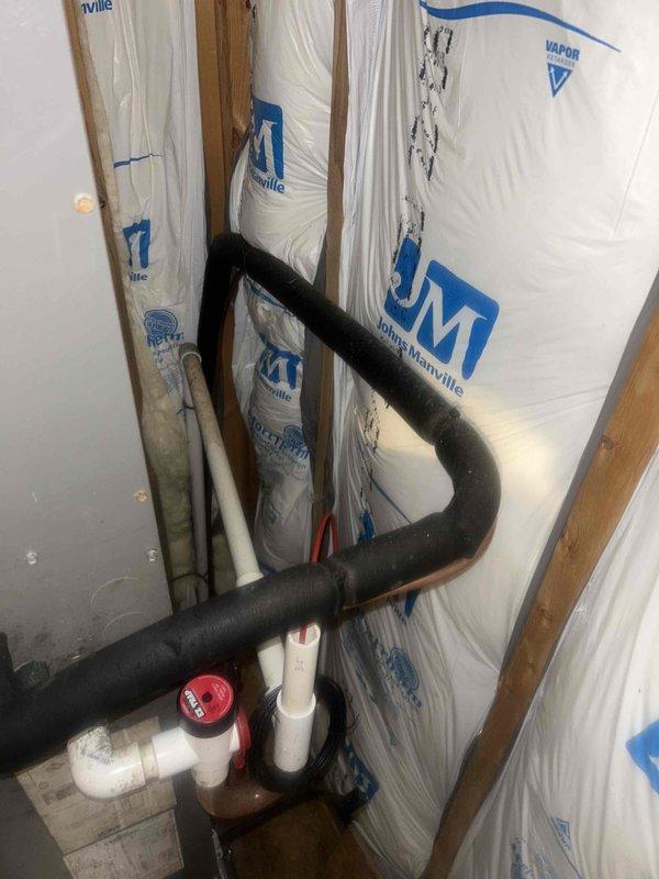 Responded to no heat call for system not maintaining temperature. Diagnosed issue with temperature differential between actual room temperature (65°F) and thermostat set point (71°F). Inspected wall cavity revealing proper insulation with Johns Manville vapor barrier and verified integrity of HVAC ductwork/piping. System is now operating correctly and maintaining desired temperature.