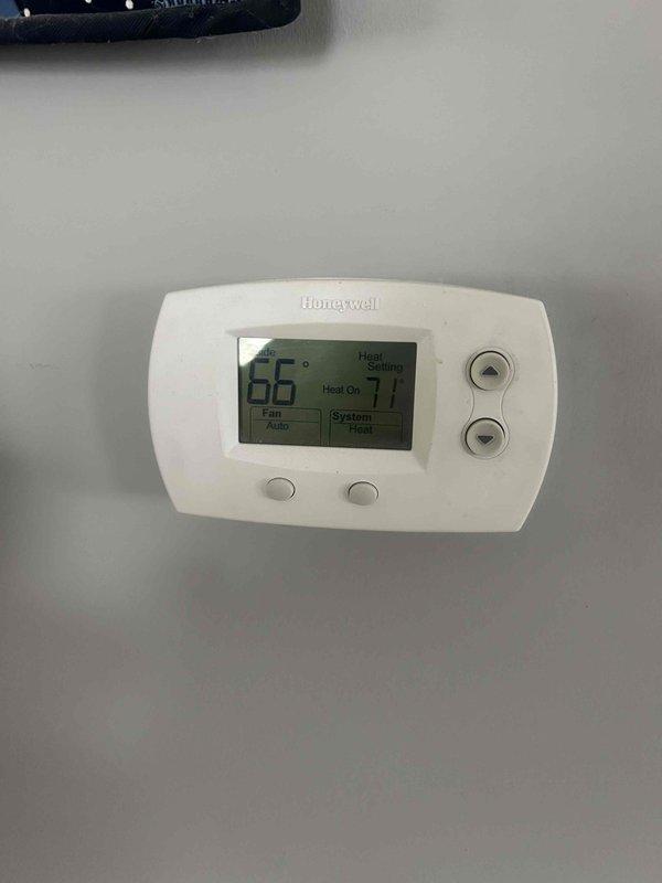 Responded to no heat call for system not maintaining temperature. Diagnosed issue with temperature differential between actual room temperature (65°F) and thermostat set point (71°F). Inspected wall cavity revealing proper insulation with Johns Manville vapor barrier and verified integrity of HVAC ductwork/piping. System is now operating correctly and maintaining desired temperature.
