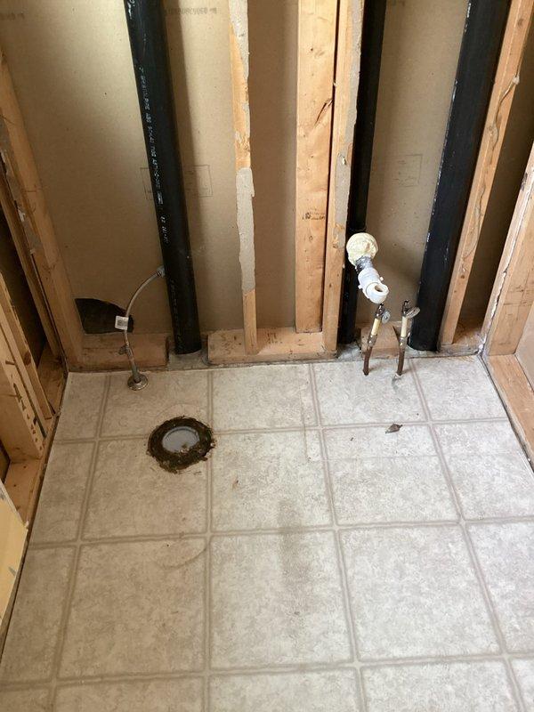 Completed initial phase of a two-visit bathroom renovation project, focusing on plumbing rough-ins. Extended water supply lines for vanities and toilets in master and hall bathrooms. Installed brushed nickel adjustable shower drain for new ceramic tile base in master bathroom. Documented existing conditions and identified requirements for second visit, which will include fixture installation and system testing.