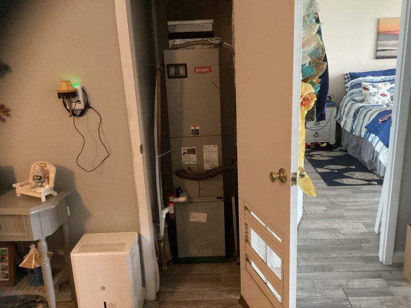 Conducted comprehensive system replacement estimate for Bryant HVAC unit located in dining room closet. Current installation includes visible ductwork and piping connections with digital thermostat showing 67°F. Documented existing setup with photos to develop appropriate replacement solution.