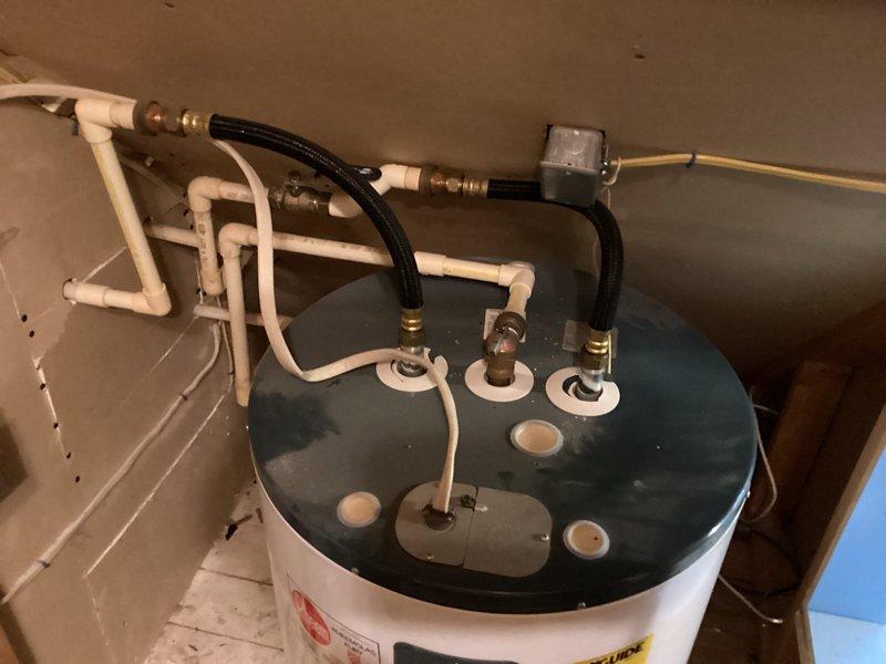 Conducted comprehensive assessment of existing water heater system, documenting current installation configuration including PVC piping, flexible connection hoses with brass fittings, and electrical control unit. Provided detailed estimate for replacement unit, noting specific requirements for proper installation in the utility area with consideration for existing wall and flooring conditions.