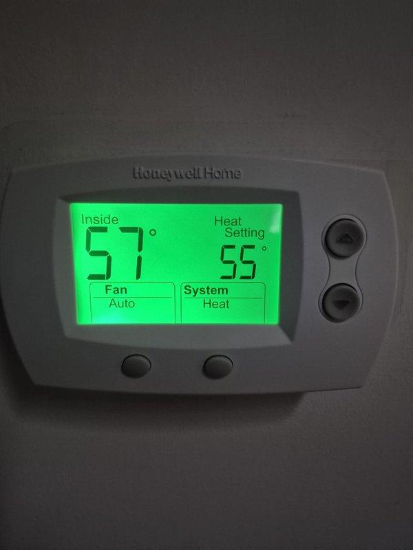Responded to no-heat service call for heat pump system that was reportedly running continuously. Upon inspection, found thermostat set to 55°F with current room temperature at 57°F, explaining why unit wasn't actively heating. Verified system operation was normal with heat pump properly cycling off when setpoint was satisfied. Checked air filter which was in acceptable condition. Educated customer on thermostat operation and relationship between temperature settings and system runtime.