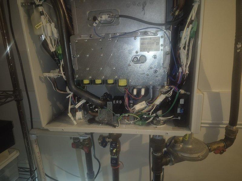 Diagnosed and repaired tankless water heater with no hot water issue by identifying faulty control board connections. Reconnected loose wiring to circuit board terminals, tested system functionality, and verified proper operation of heating elements and gas valve assembly.