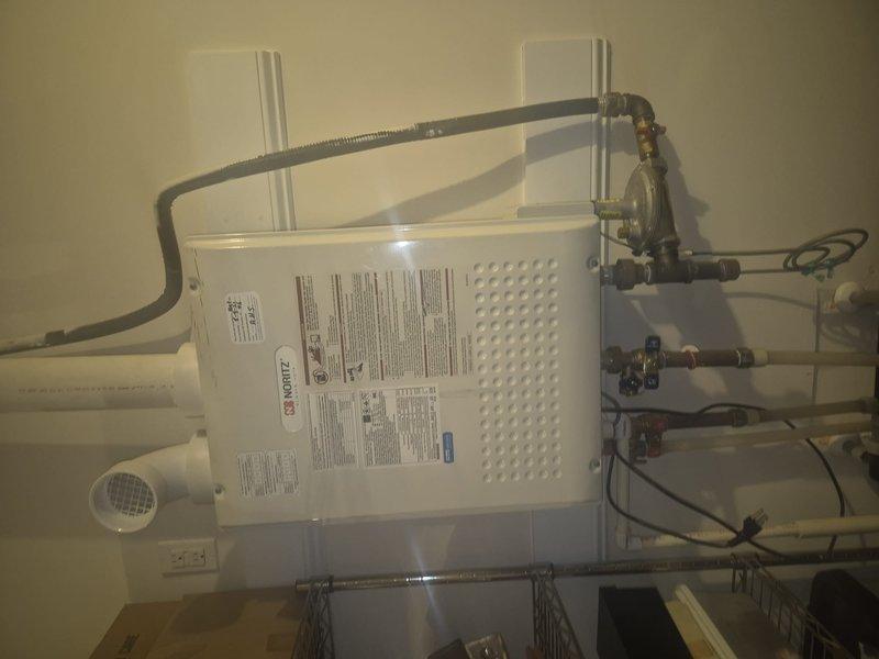 Diagnosed and repaired tankless water heater with no hot water issue by identifying faulty control board connections. Reconnected loose wiring to circuit board terminals, tested system functionality, and verified proper operation of heating elements and gas valve assembly.