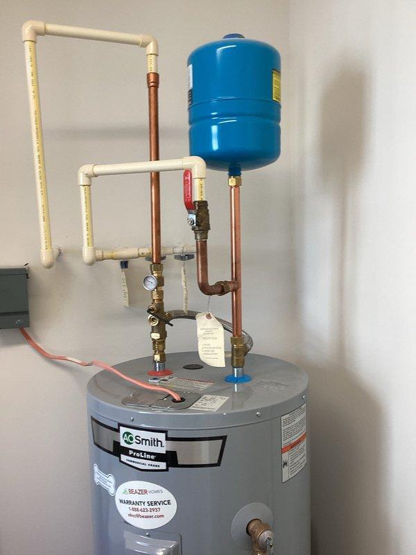 Responded to no hot water complaint on A.O. Smith ProLine water heater. Inspected system including pressure/temperature gauge, expansion tank, and valve assembly. Diagnosed and repaired issue, restoring hot water functionality with temperature now reading approximately 60-65 degrees.