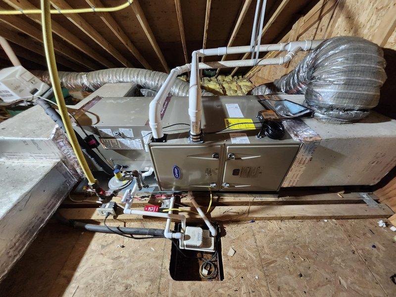 Completed comprehensive HVAC system replacement with installation of dual Carrier systems: a 2.5-ton unit for the first floor and a 2.0-ton unit for the second floor. Work included removal and disposal of existing systems, installation of new furnaces in attic with drain pan and safety shutoff, condensation pump setup, pressure testing and recharging of refrigeration lines, and configuration of new digital thermostats throughout the home.