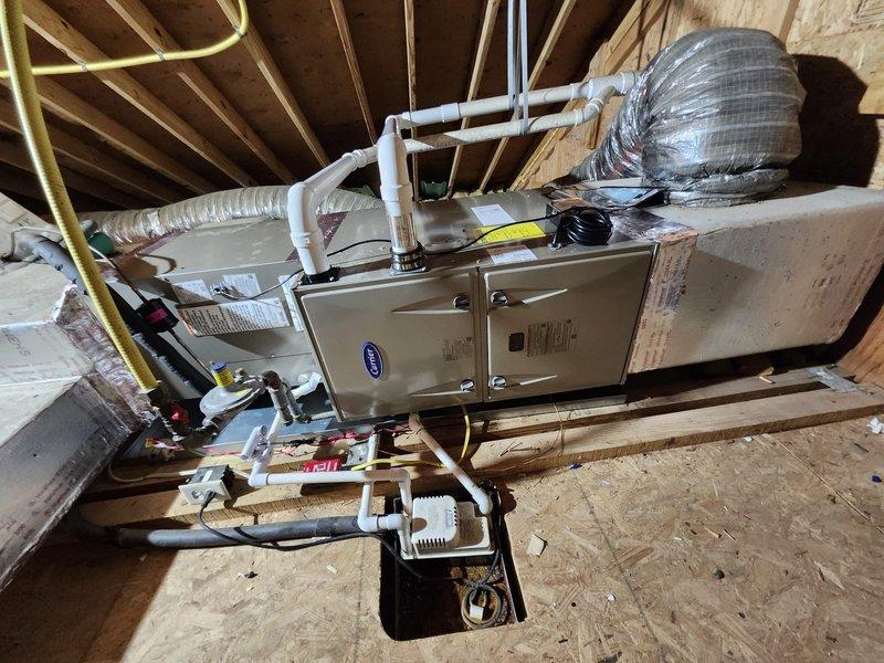 Completed comprehensive HVAC system replacement with installation of dual Carrier systems: a 2.5-ton unit for the first floor and a 2.0-ton unit for the second floor. Work included removal and disposal of existing systems, installation of new furnaces in attic with drain pan and safety shutoff, condensation pump setup, pressure testing and recharging of refrigeration lines, and configuration of new digital thermostats throughout the home.