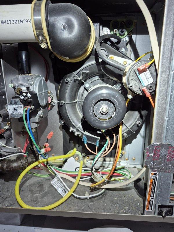 Responded to no-heat service call for unit under 10 years old. Diagnosed ignition failure at manifold assembly. Removed and cleaned flame sensor and burner orifices to restore proper ignition sequence, then verified normal operation through complete heating cycle.