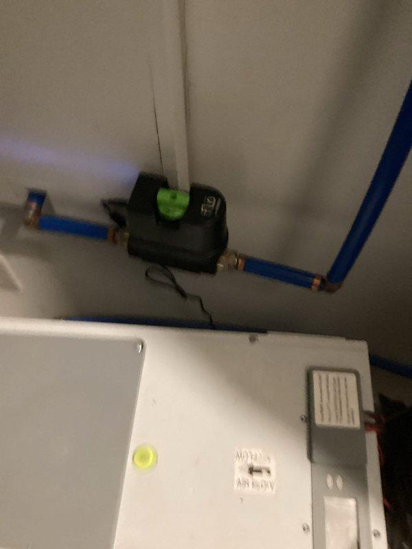 Performed remote diagnostics and service on tankless water heater system. Inspected PEX piping connections and control valve assembly with green indicator. Verified proper operation of circulation pump and pressure gauge readings. System was successfully restored to normal functionality with all connections secure and operating within specifications.