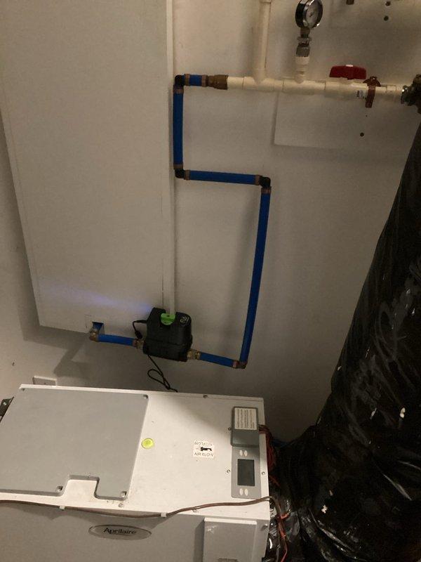 Performed remote diagnostics and service on tankless water heater system. Inspected PEX piping connections and control valve assembly with green indicator. Verified proper operation of circulation pump and pressure gauge readings. System was successfully restored to normal functionality with all connections secure and operating within specifications.