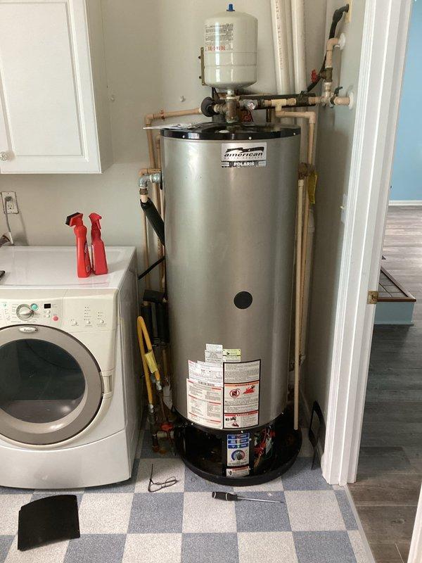 Responded to service call for multiple leak issues and water heater repairs. Addressed heavy corrosion at water heater connections and replaced waterlogged expansion tank. Fixed leaks in multiple locations including under master bathroom, second floor sink with slow drainage, loose toilet in half bath, and laundry sink. Noted HVAC system with missing filter in master bedroom closet and visible frost buildup on exterior refrigerant lines indicating potential cooling system issues.