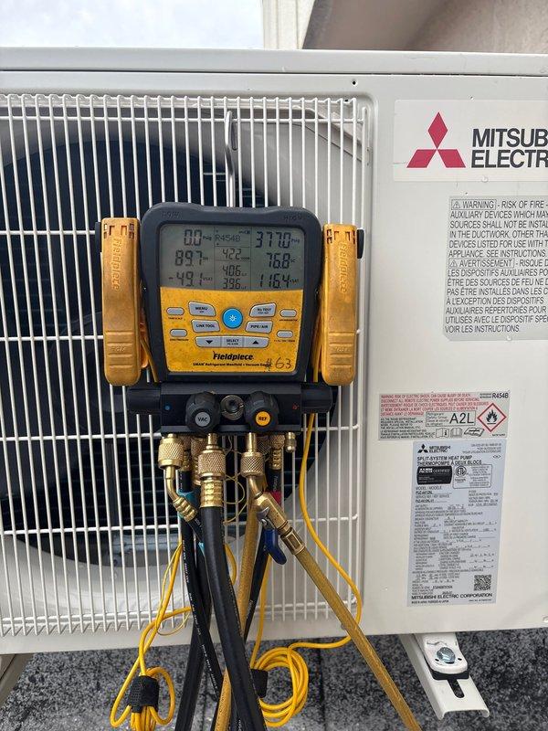 Successfully installed and tested a Mitsubishi Electric HVAC system including PUZ-AK12NL heat pump outdoor unit mounted on wall bracket and PKA-AL12NL fan coil unit with wireless remote. System installation included refrigeration and condensation lines concealed in metal top hat with fire caulking, automatic Gobi II condensation pump, and surge disconnect, with all components verified operational through temperature and pressure diagnostics.