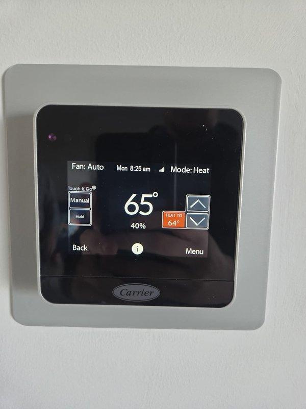 Performed routine maintenance on Carrier heating system. Verified thermostat functionality (65°F, 40% humidity, Heat mode) and conducted electrical diagnostics with clamp meter showing 0.6A current draw, confirming proper operation. System is functioning within normal parameters.
