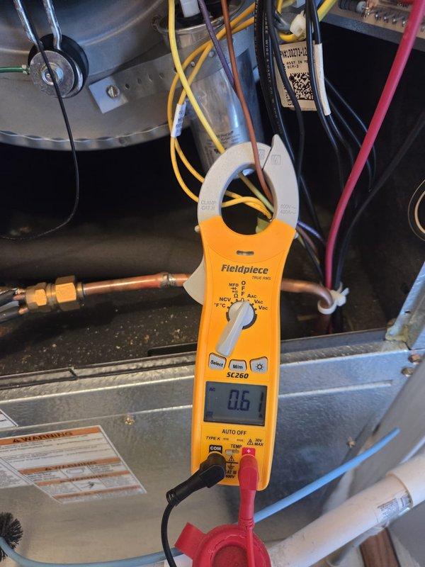 Performed routine maintenance on Carrier heating system. Verified thermostat functionality (65°F, 40% humidity, Heat mode) and conducted electrical diagnostics with clamp meter showing 0.6A current draw, confirming proper operation. System is functioning within normal parameters.