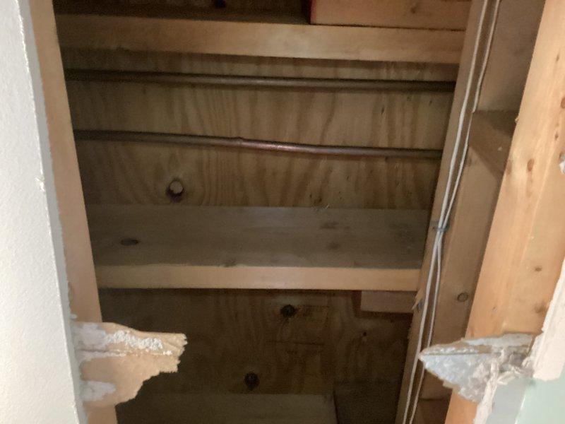 Responded to frozen pipe emergency; discovered cracked brass ball valve at main water supply and disconnected heat tape under the house. Upon inspection, found non-functional heating system, ice in first floor toilet bowl, and water leakage in kitchen cabinet adjacent to water heater. Reconnected heat tape power supply and isolated water supply to prevent further damage until heating system replacement and plumbing repairs can be completed.