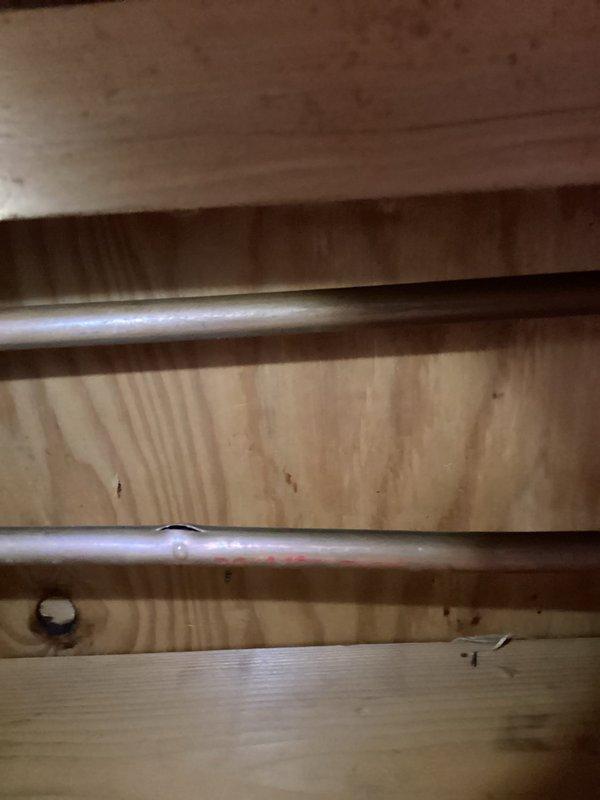 Responded to frozen pipe emergency; discovered cracked brass ball valve at main water supply and disconnected heat tape under the house. Upon inspection, found non-functional heating system, ice in first floor toilet bowl, and water leakage in kitchen cabinet adjacent to water heater. Reconnected heat tape power supply and isolated water supply to prevent further damage until heating system replacement and plumbing repairs can be completed.