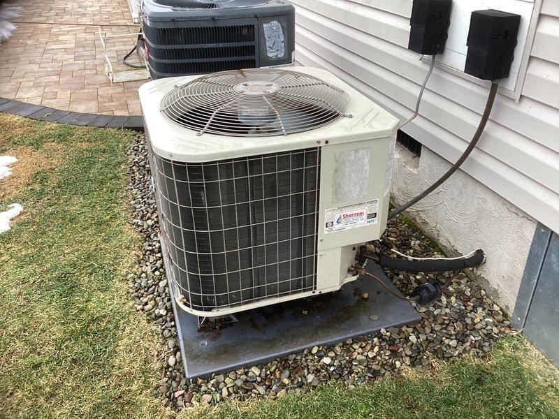 Performed site assessment for potential system replacement of existing Coleman outdoor unit and indoor furnace. Customer is interested in upgrading to a Carrier inverter system. Current installation includes an aging Coleman condensing unit on concrete pad with visible weathering, alongside a standard efficiency furnace with conventional ductwork in utility space. Installation timeline targeted for early April.