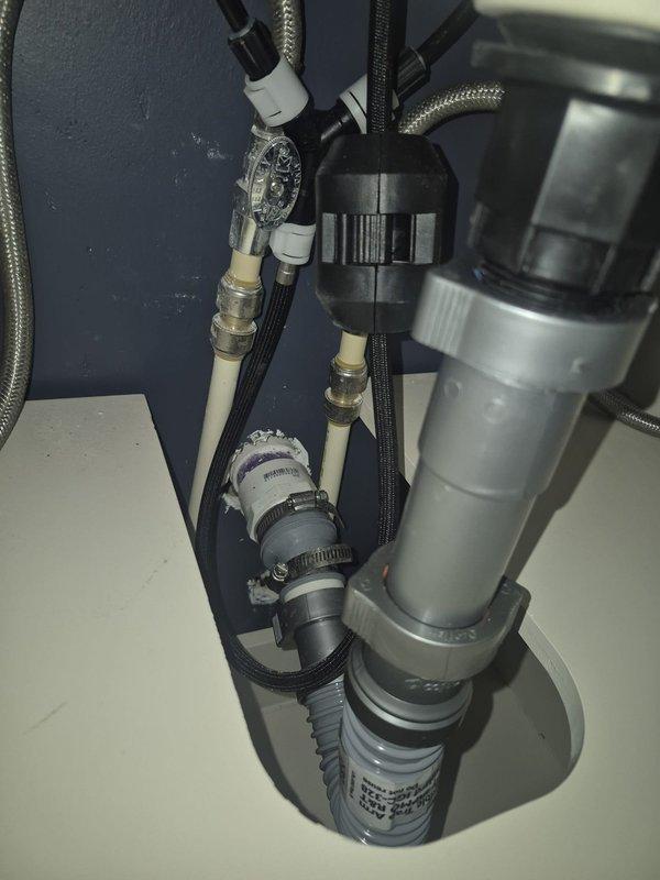 Conducted a comprehensive inspection of kitchen sink plumbing, noting non-code-compliant piping and missing trap. Evaluated existing drainage system with corrugated plastic pipes and metal braided supply lines. Also performed assessment of bathroom plumbing fixtures as requested. Documented conditions with detailed photos for estimate preparation.